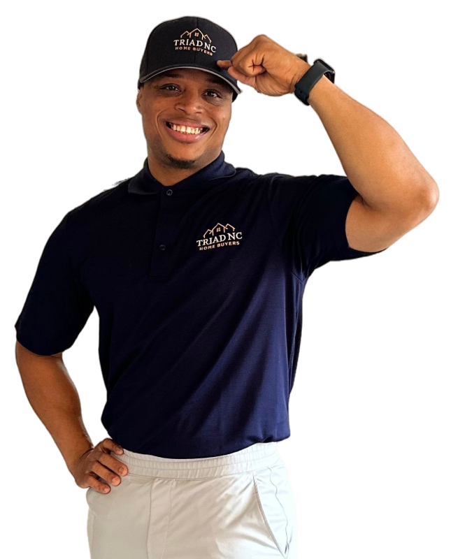 Mac Herbert - hand on his cap Portrait of a smiling male real estate expert wearing a branded navy polo shirt.